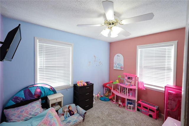 bedroom featuring carpet flooring, ceiling fan, and a textured ceiling