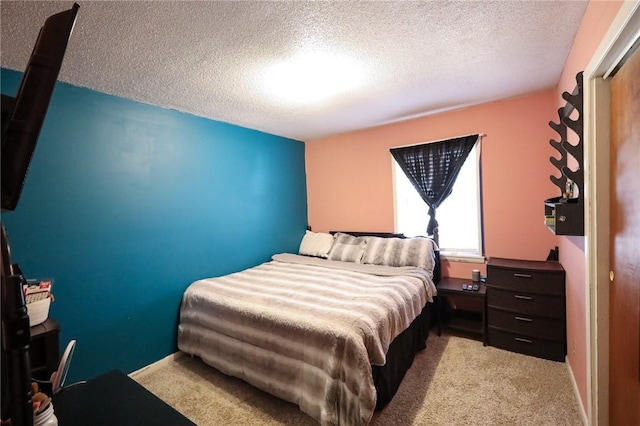 bedroom featuring a textured ceiling and light carpet