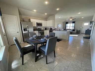 dining room featuring ceiling fan and vaulted ceiling