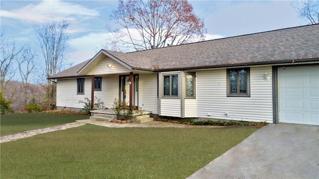 ranch-style house featuring a garage and a front lawn