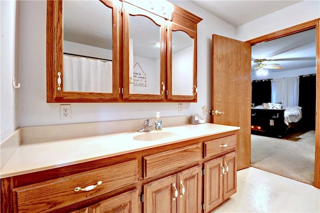 ensuite bathroom featuring vanity, ceiling fan, and connected bathroom