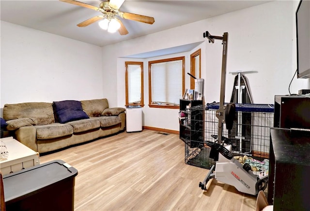 living room with wood-type flooring and ceiling fan