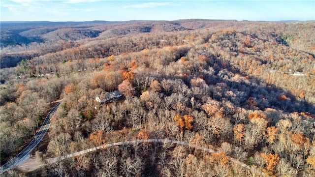 aerial view featuring a wooded view