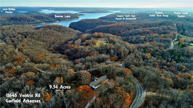 aerial view with a forest view and a water view