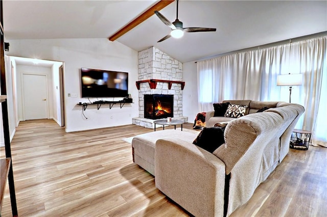 living room with light wood-style floors, a fireplace, baseboards, ceiling fan, and vaulted ceiling with beams