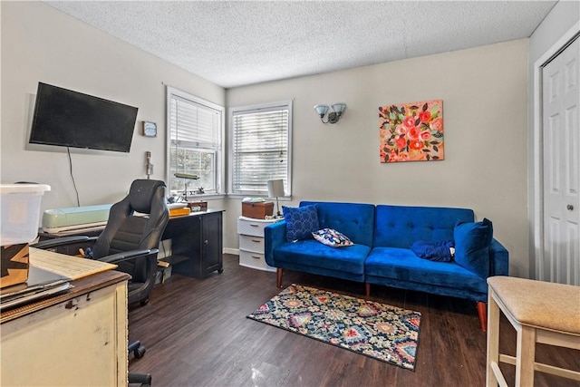 office area featuring baseboards, wood finished floors, and a textured ceiling