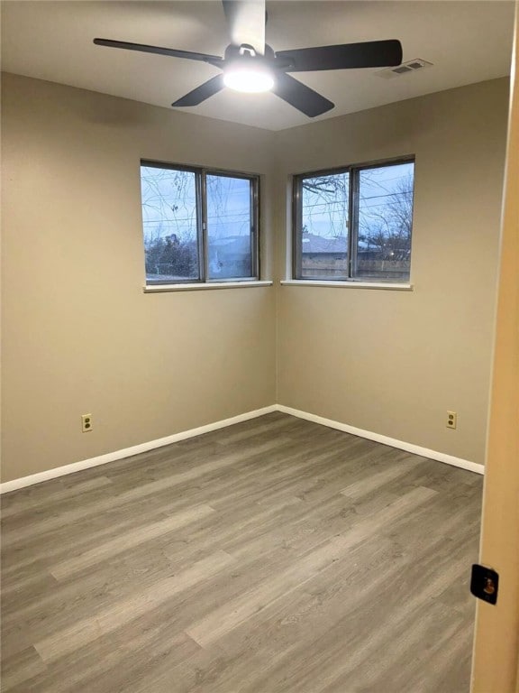 unfurnished room with wood-type flooring and ceiling fan