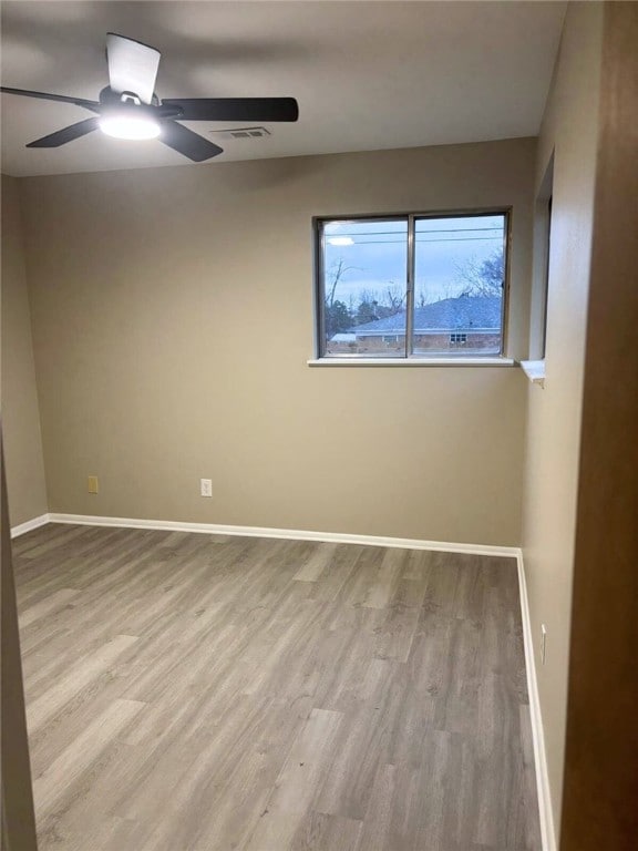 unfurnished room featuring ceiling fan and light hardwood / wood-style flooring