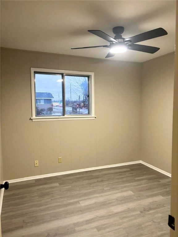 spare room with hardwood / wood-style flooring and ceiling fan