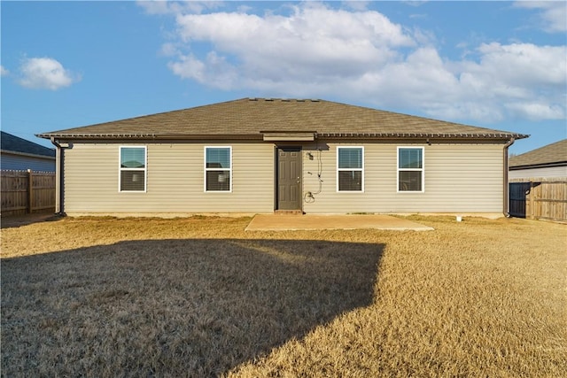 rear view of property with a lawn