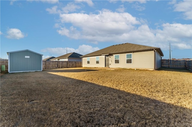 rear view of property featuring a storage unit and a yard