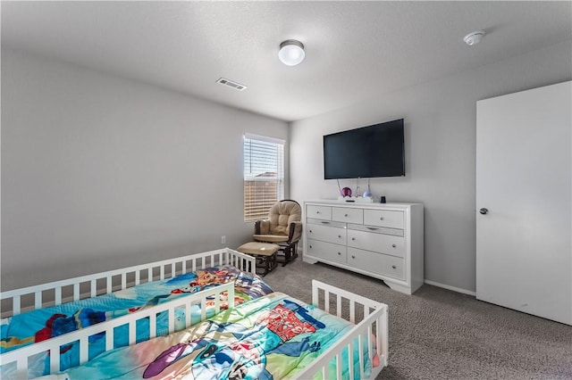 bedroom featuring carpet floors and a textured ceiling