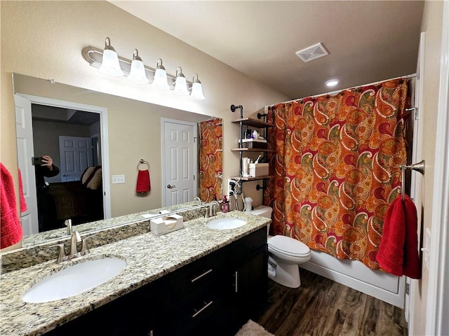 full bathroom featuring vanity, hardwood / wood-style flooring, toilet, and shower / bath combo with shower curtain