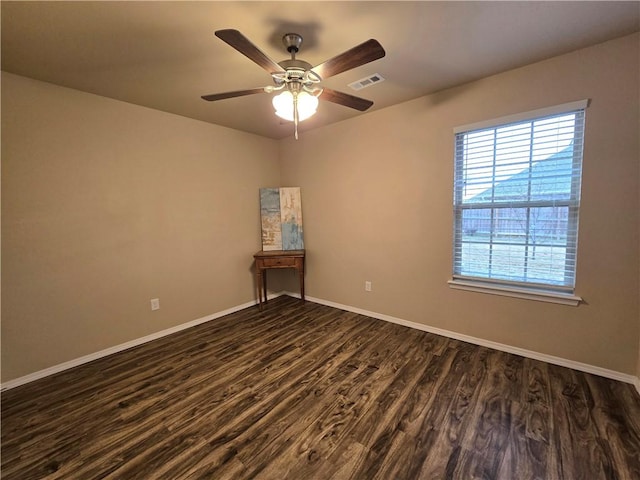 spare room featuring ceiling fan and dark hardwood / wood-style flooring