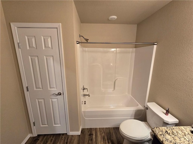 full bathroom featuring hardwood / wood-style flooring, vanity, shower / bathtub combination, and toilet