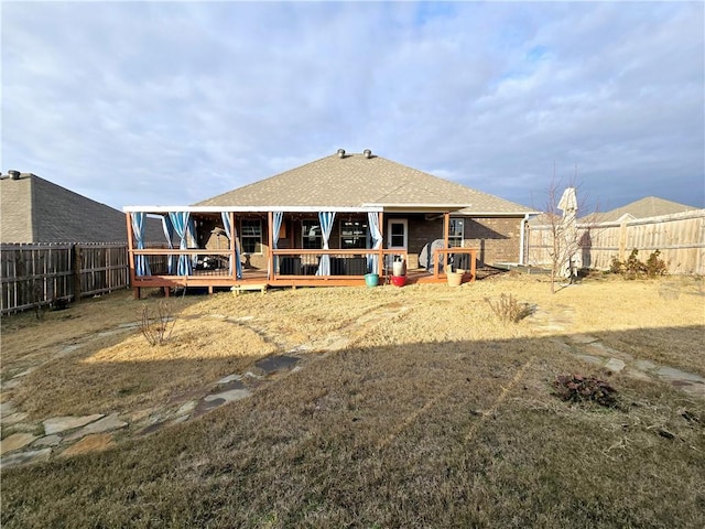 rear view of house featuring a wooden deck