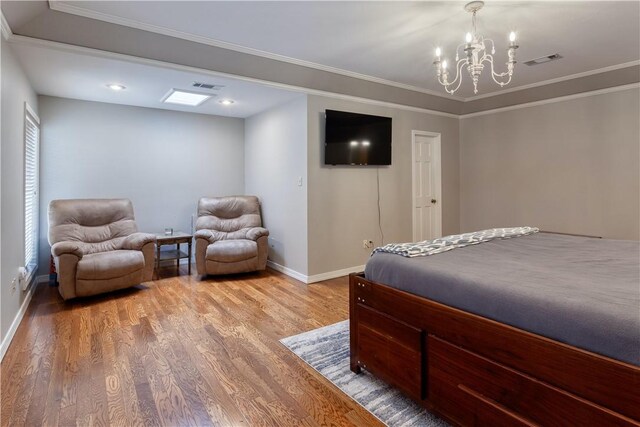 bedroom featuring hardwood / wood-style floors, an inviting chandelier, and ornamental molding