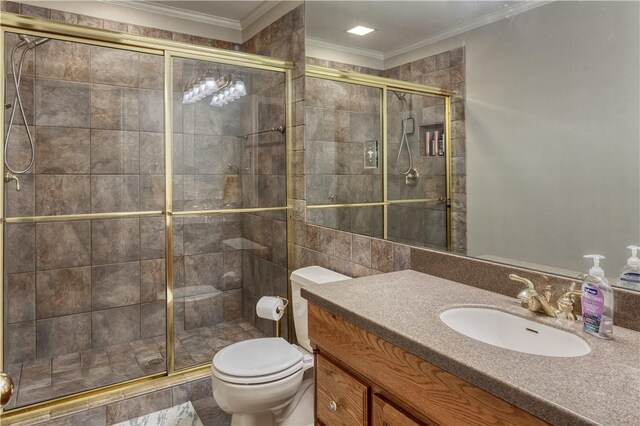 bathroom with an enclosed shower, vanity, toilet, and ornamental molding