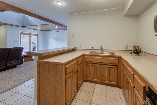 kitchen with kitchen peninsula, stainless steel oven, light tile patterned flooring, and sink