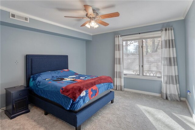 carpeted bedroom with ceiling fan and crown molding