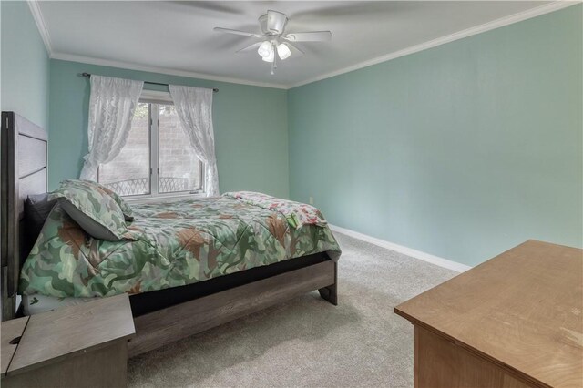 bedroom with carpet flooring, ceiling fan, and ornamental molding