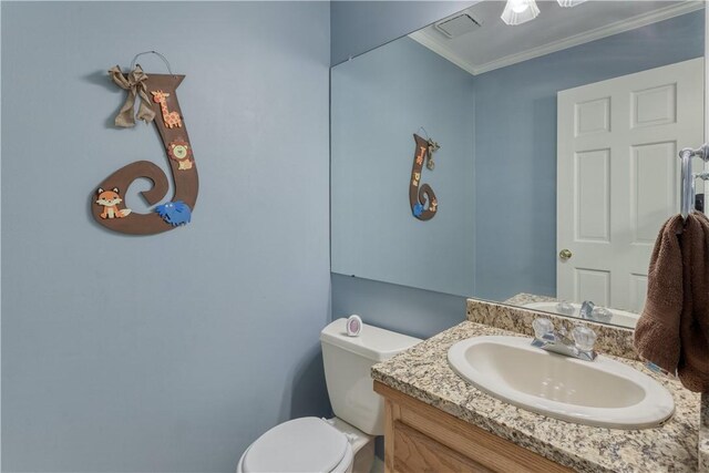 bathroom featuring vanity, toilet, and crown molding