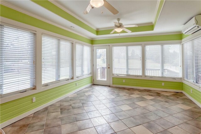 unfurnished sunroom with a wall mounted AC, a raised ceiling, and ceiling fan