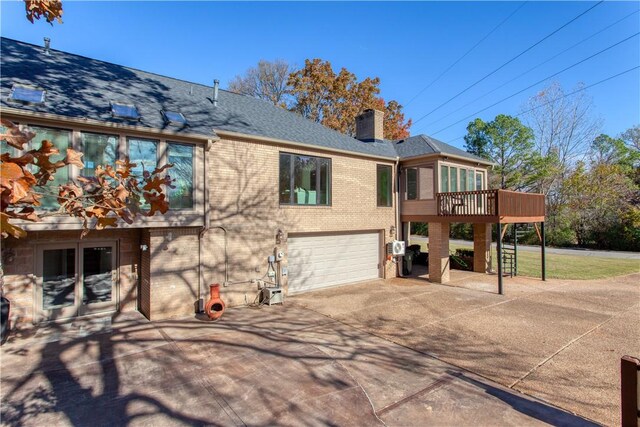 view of front of home featuring a garage and a wooden deck