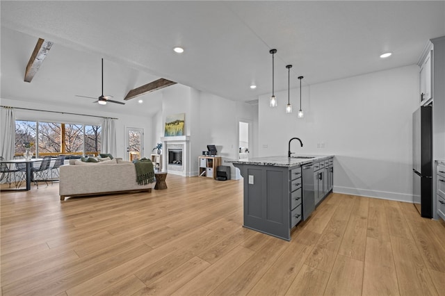 kitchen featuring hanging light fixtures, gray cabinetry, light hardwood / wood-style flooring, and stainless steel appliances