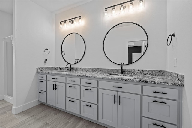 bathroom with vanity and wood-type flooring