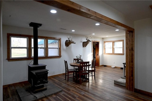 dining room featuring hardwood / wood-style flooring and a wood stove