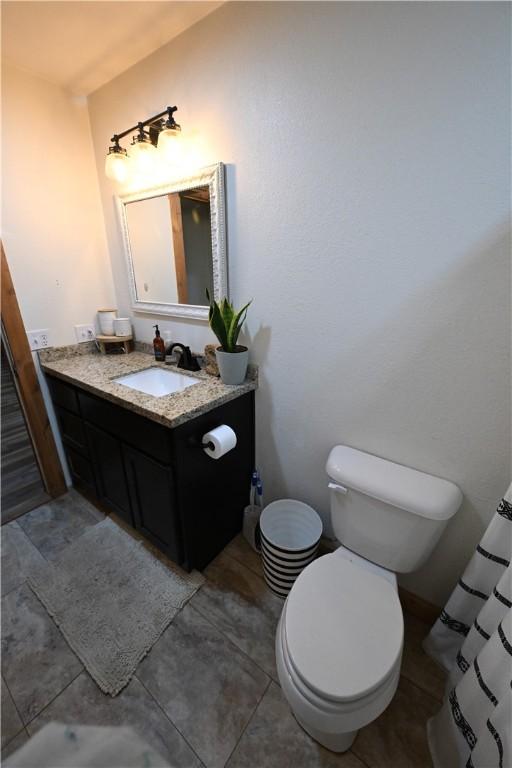 bathroom with tile patterned floors, vanity, and toilet