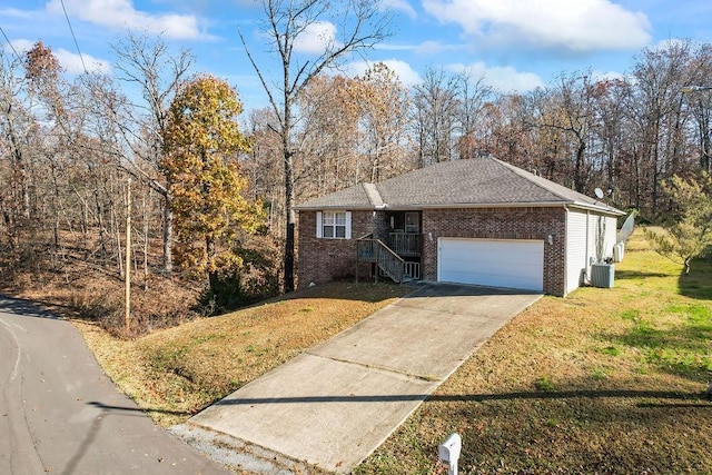 ranch-style house with a front yard, central AC, and a garage