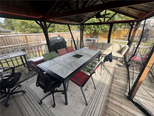 1007 N Quail Ter, Rogers, AR 72756 - wooden terrace with a gazebo, outdoor dining space, a fenced backyard, and area for grilling