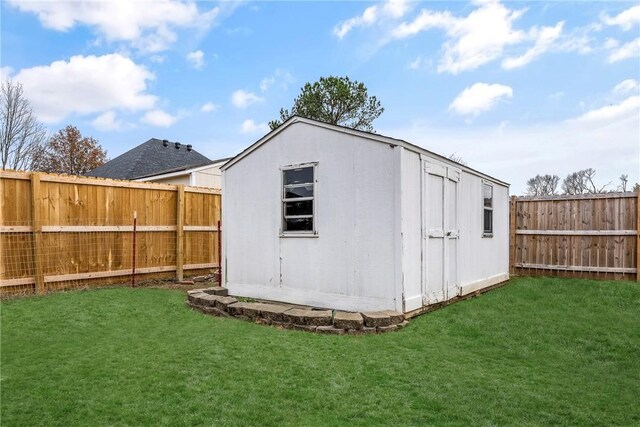 view of outdoor structure featuring a lawn