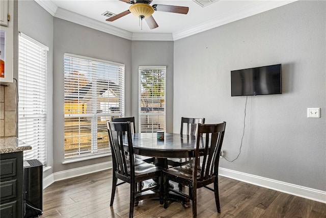 dining area featuring ceiling fan, crown molding, and dark wood-type flooring