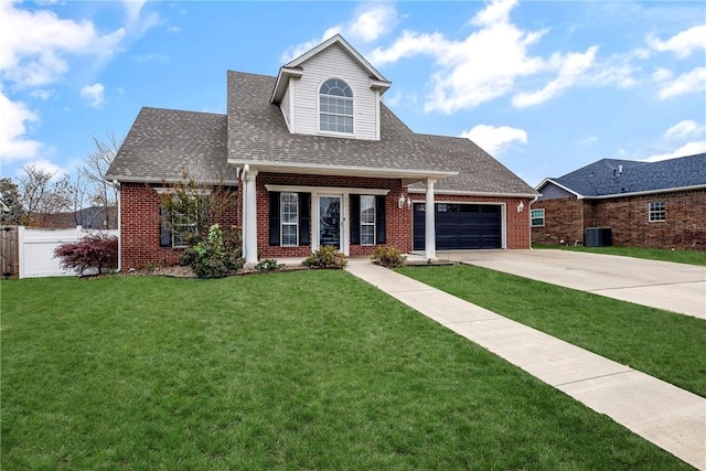 view of front of property with cooling unit, covered porch, a front yard, and a garage