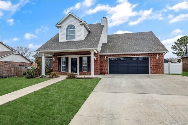 view of front of house featuring a front yard, a porch, and a garage