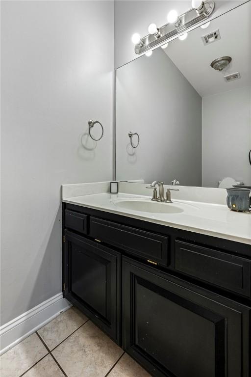 1007 N Quail Ter, Rogers, AR 72756 - bathroom with vanity, tile patterned floors, and baseboards