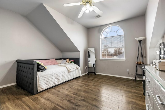 bedroom with ceiling fan, dark wood-type flooring, and vaulted ceiling