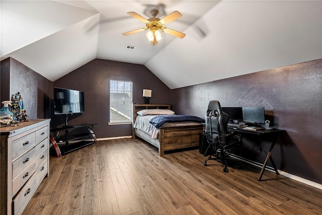 bedroom featuring hardwood / wood-style floors, ceiling fan, and lofted ceiling