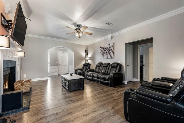 1007 N Quail Ter, Rogers, AR 72756 - living area featuring arched walkways, a ceiling fan, crown molding, dark wood-style flooring, and a brick fireplace