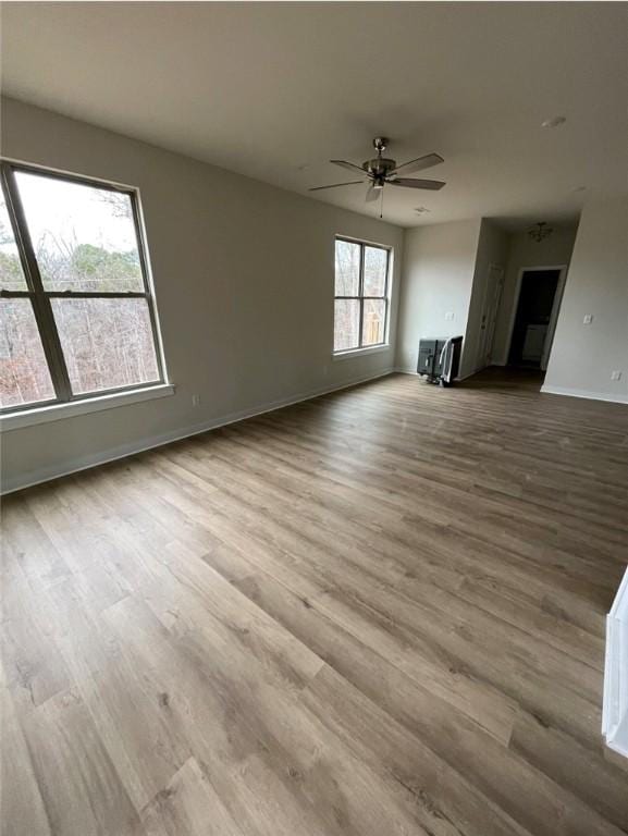 unfurnished living room featuring light hardwood / wood-style floors and ceiling fan