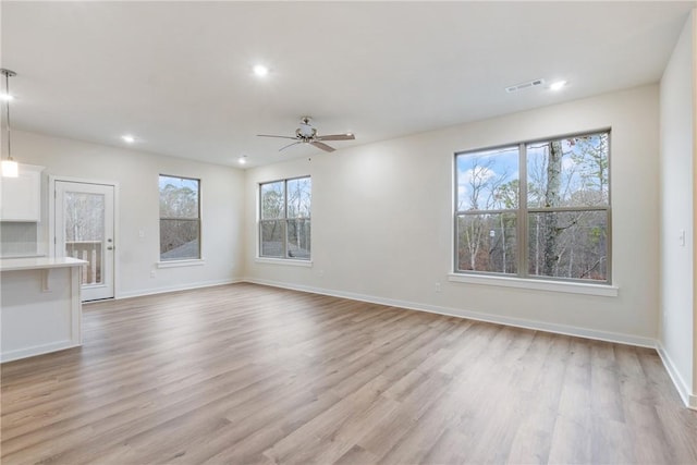 unfurnished living room featuring light hardwood / wood-style floors and ceiling fan