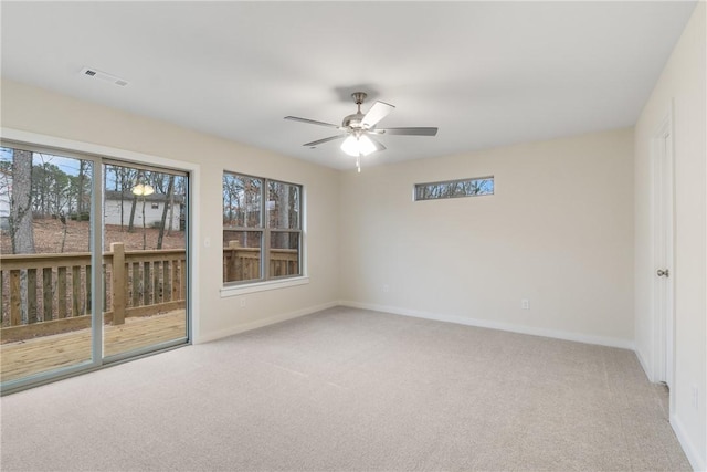 carpeted spare room with ceiling fan