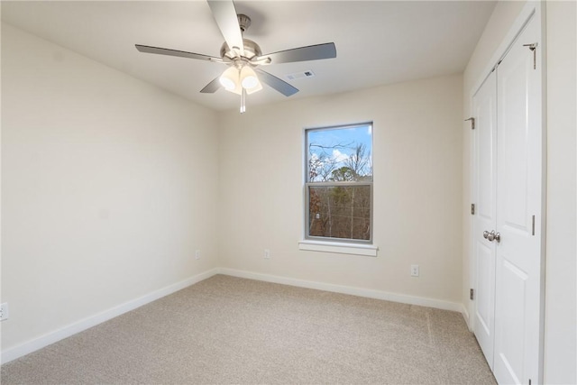 unfurnished bedroom with a closet, ceiling fan, and carpet flooring