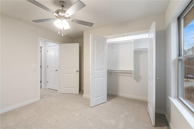 unfurnished bedroom with ceiling fan, light colored carpet, and a closet