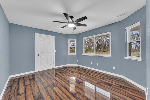 empty room featuring ceiling fan and hardwood / wood-style floors