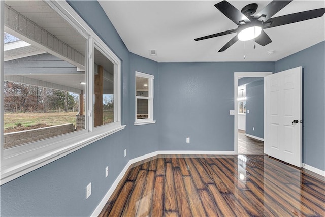 spare room with ceiling fan and dark hardwood / wood-style floors