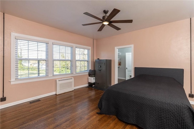 bedroom with dark hardwood / wood-style floors and ceiling fan